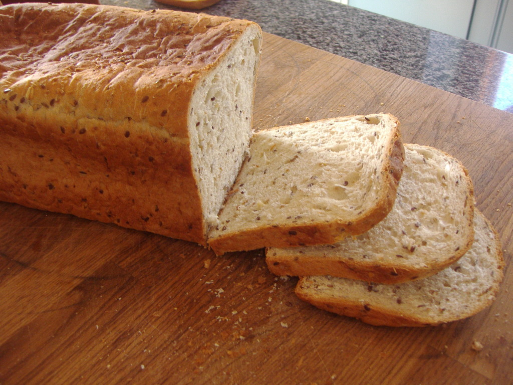 A loaf of bread is cut in half on the counter.